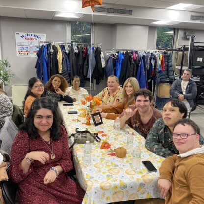 A group of teens sitting around a table.