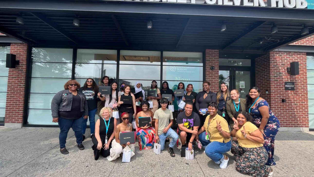 A group of women posing in front of the jack & shirley silver hub.