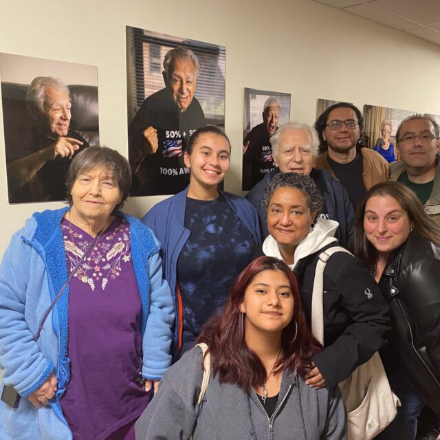 A group of people posing for a photo in a hallway.
